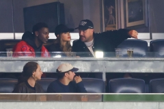 Taylor and Travis are watching a baseball game in New York